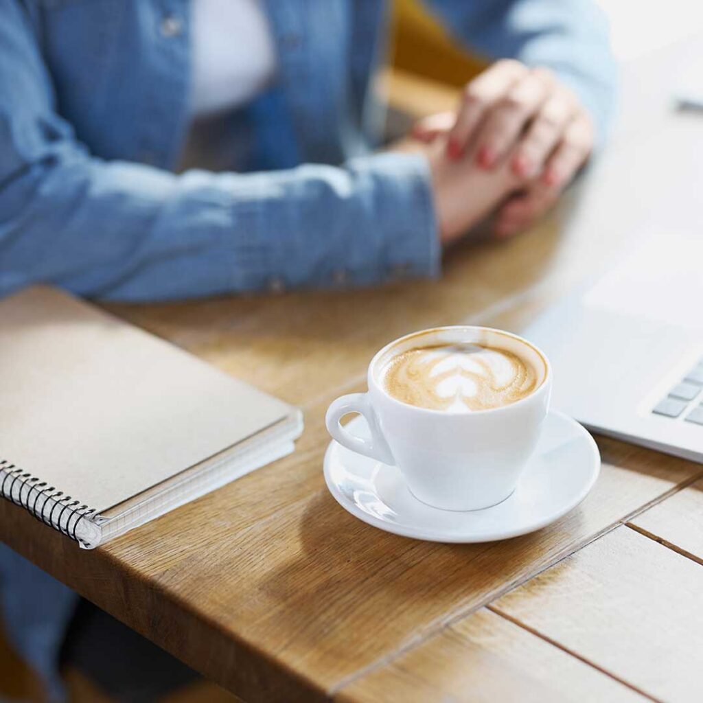 Cup of fresh cappuccino in the office